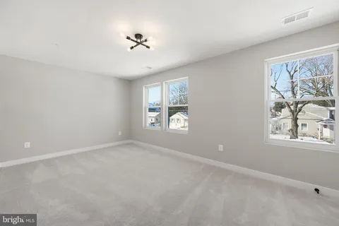 an empty room with windows and closet