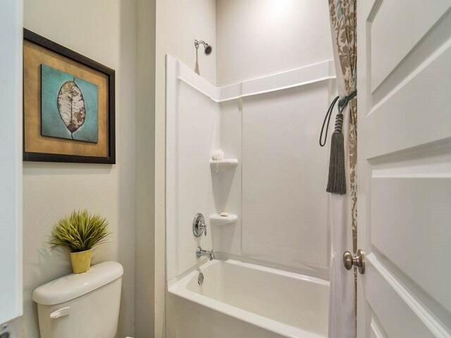 2535 Rutgers Road Crestview, FL 32536 - Photo 16 of 21 a bathroom with a shower a toilet a sink and mirror