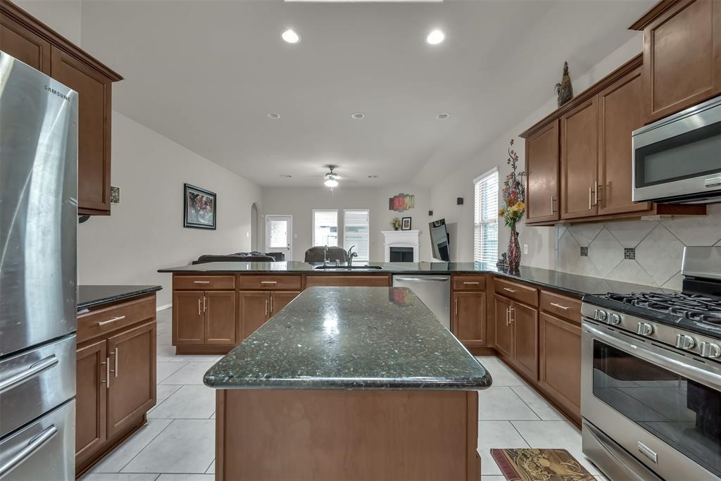 5415 Glenfield Spring Lane Spring, TX 77389 - Photo 11 of 16 a kitchen with granite countertop a stove and a sink