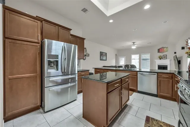 a kitchen with a refrigerator sink and cabinets