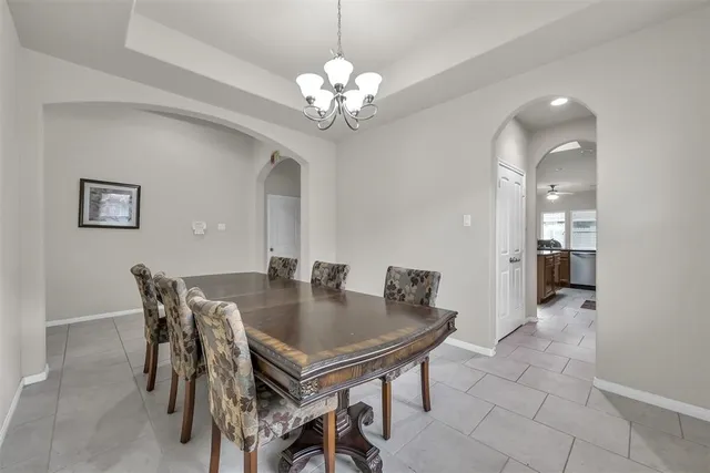 a view of a dining room with furniture and chandelier