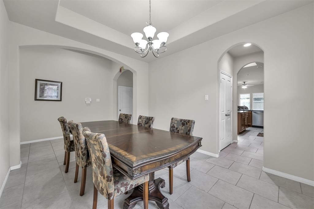 5415 Glenfield Spring Lane Spring, TX 77389 - Photo 3 of 16 a view of a dining room with furniture and chandelier