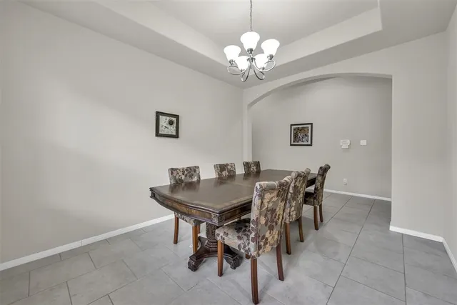 a view of a dining room with furniture and chandelier