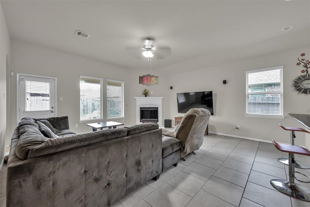 5415 Glenfield Spring Lane Spring, TX 77389 - Photo 6 of 16 a living room with furniture a fireplace and a flat screen tv