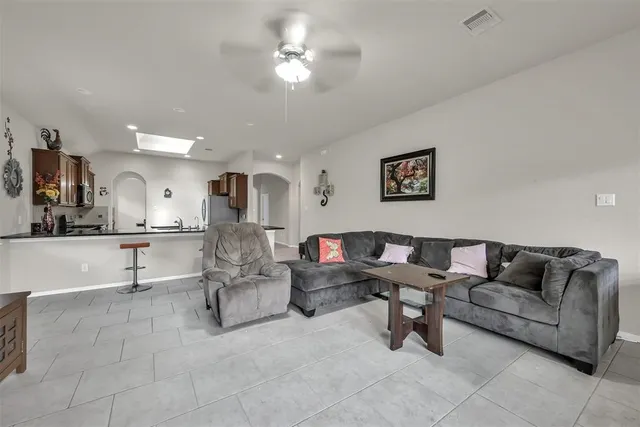 a living room with furniture and kitchen view