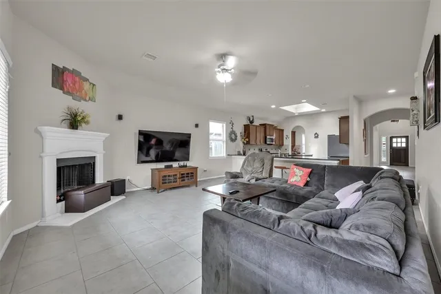 a living room with furniture a flat screen tv and a fireplace
