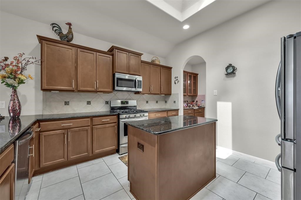 5415 Glenfield Spring Lane Spring, TX 77389 - Photo 9 of 16 a kitchen with stainless steel appliances granite countertop a stove a sink and a refrigerator