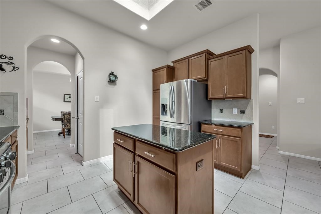 5415 Glenfield Spring Lane Spring, TX 77389 - Photo 10 of 16 a kitchen with stainless steel appliances granite countertop a refrigerator and a stove