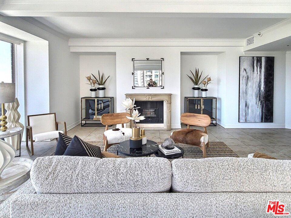 10550 Wilshire Boulevard, Unit 1004 Los Angeles, CA 90024 - Photo 12 of 39 a living room with furniture and a fireplace