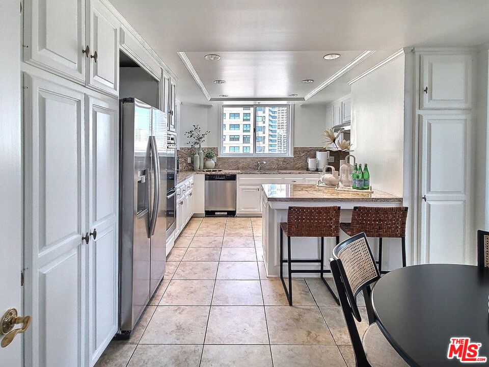 10550 Wilshire Boulevard, Unit 1004 Los Angeles, CA 90024 - Photo 15 of 39 a dining hall with stainless steel appliances granite countertop furniture and a kitchen view
