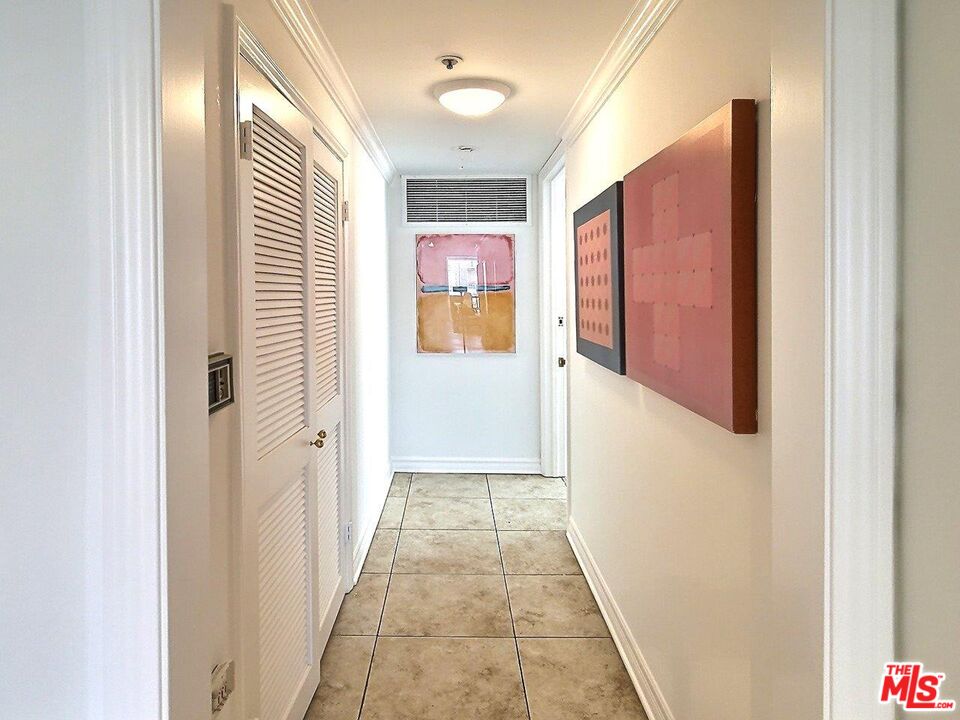 10550 Wilshire Boulevard, Unit 1004 Los Angeles, CA 90024 - Photo 23 of 39 a view of a hallway with wooden floor and staircase