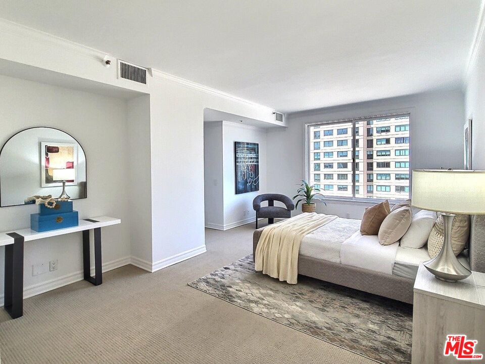 10550 Wilshire Boulevard, Unit 1004 Los Angeles, CA 90024 - Photo 24 of 39 a bedroom with a bed and a large window