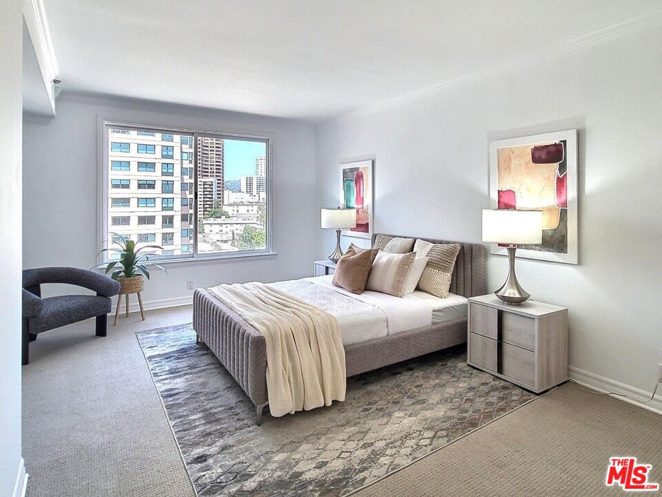 10550 Wilshire Boulevard, Unit 1004 Los Angeles, CA 90024 - Photo 25 of 39 a spacious bedroom with a bed and a couch