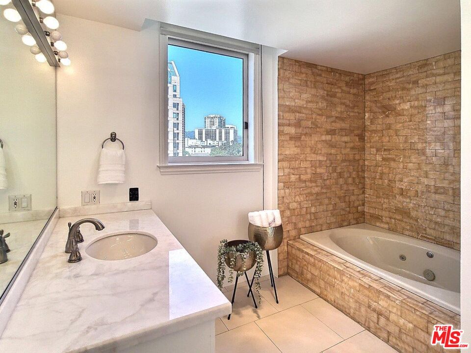 10550 Wilshire Boulevard, Unit 1004 Los Angeles, CA 90024 - Photo 31 of 39 a bathroom with a tub a sink and a window