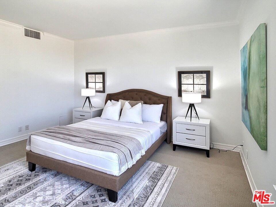10550 Wilshire Boulevard, Unit 1004 Los Angeles, CA 90024 - Photo 35 of 39 a bedroom with bed and a window