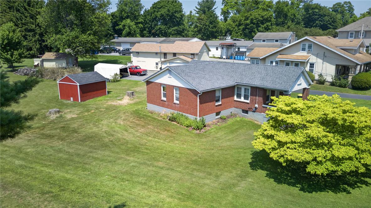 1166 Stones Crossing Road Easton, PA 18045 - Photo 24 of 35 A classic brick residence anchors a sprawling, manicured lawn with mature trees and outbuildings.