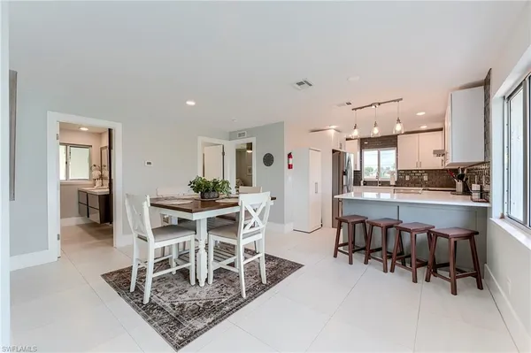 a dining room with kitchen island a table and chairs