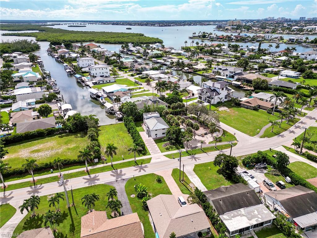 145 Capri Boulevard Naples, FL 34113 - Photo 17 of 33 an aerial view of residential building and lake