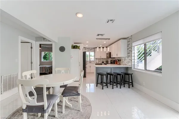 a dining room with furniture and window