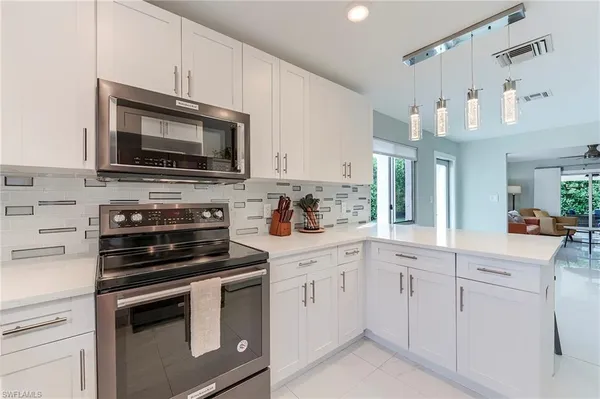 a kitchen with a sink stove and microwave