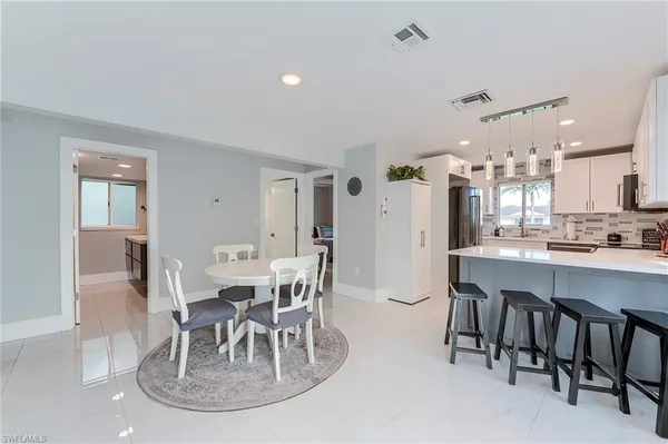 a dining room with furniture and chandelier