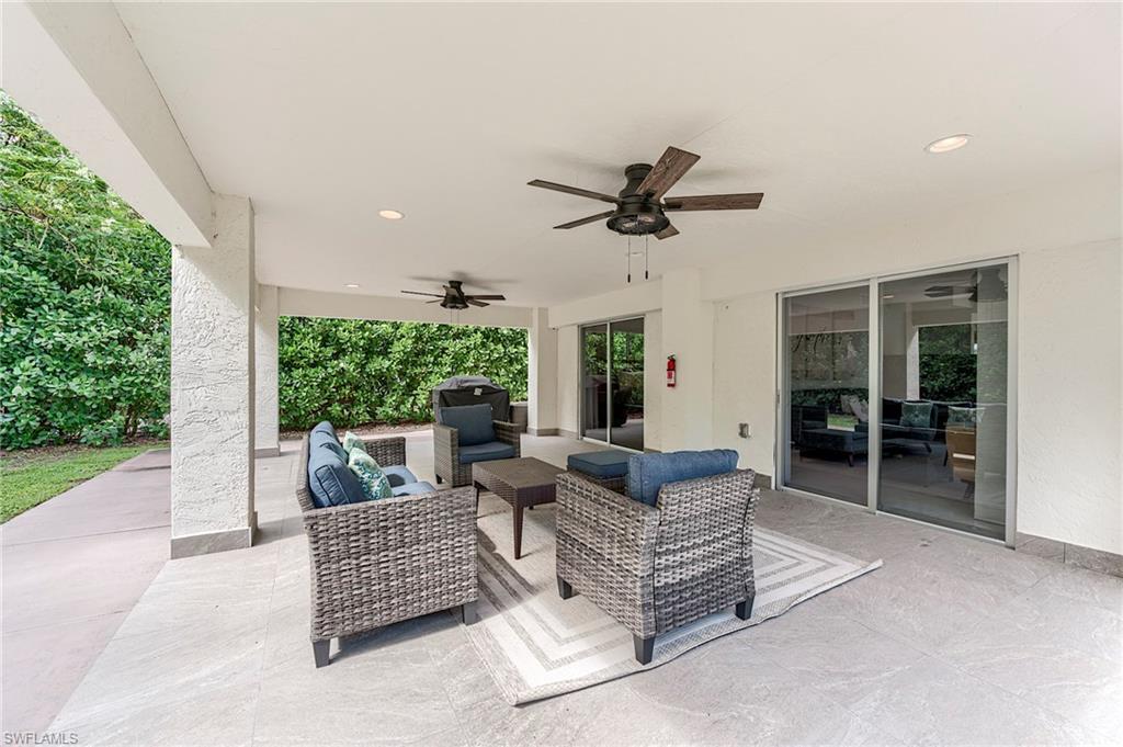 145 Capri Boulevard Naples, FL 34113 - Photo 26 of 33 a living room with furniture and a large window