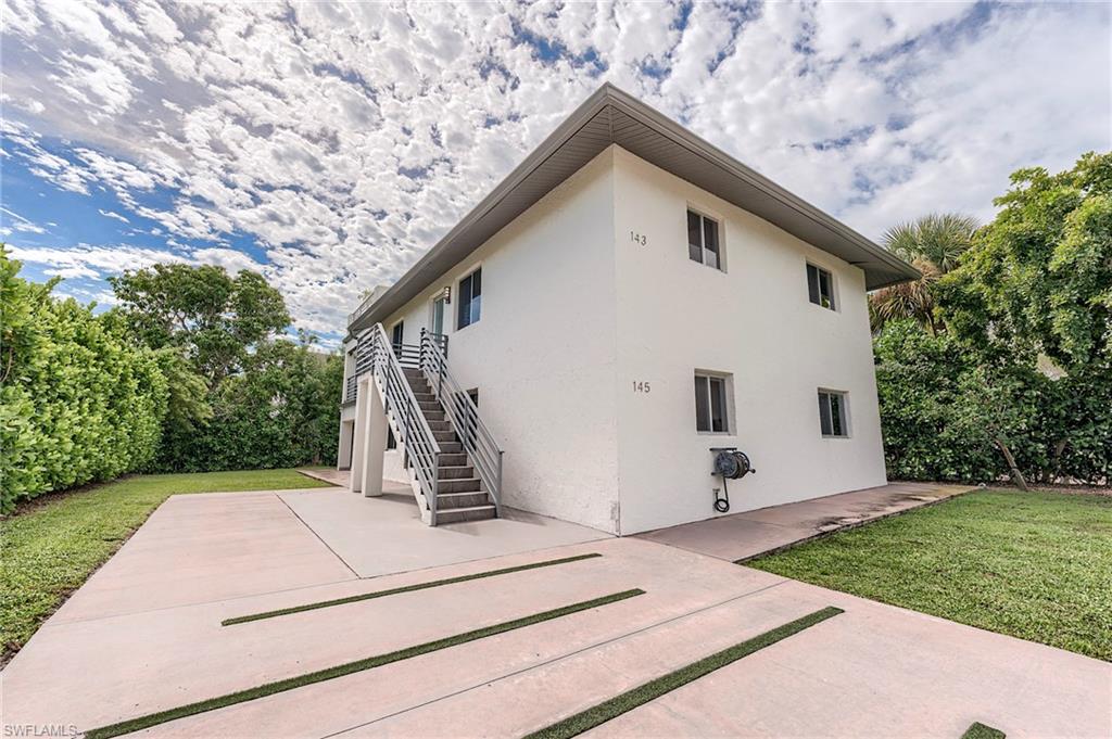 145 Capri Boulevard Naples, FL 34113 - Photo 28 of 33 a view of a house with a yard
