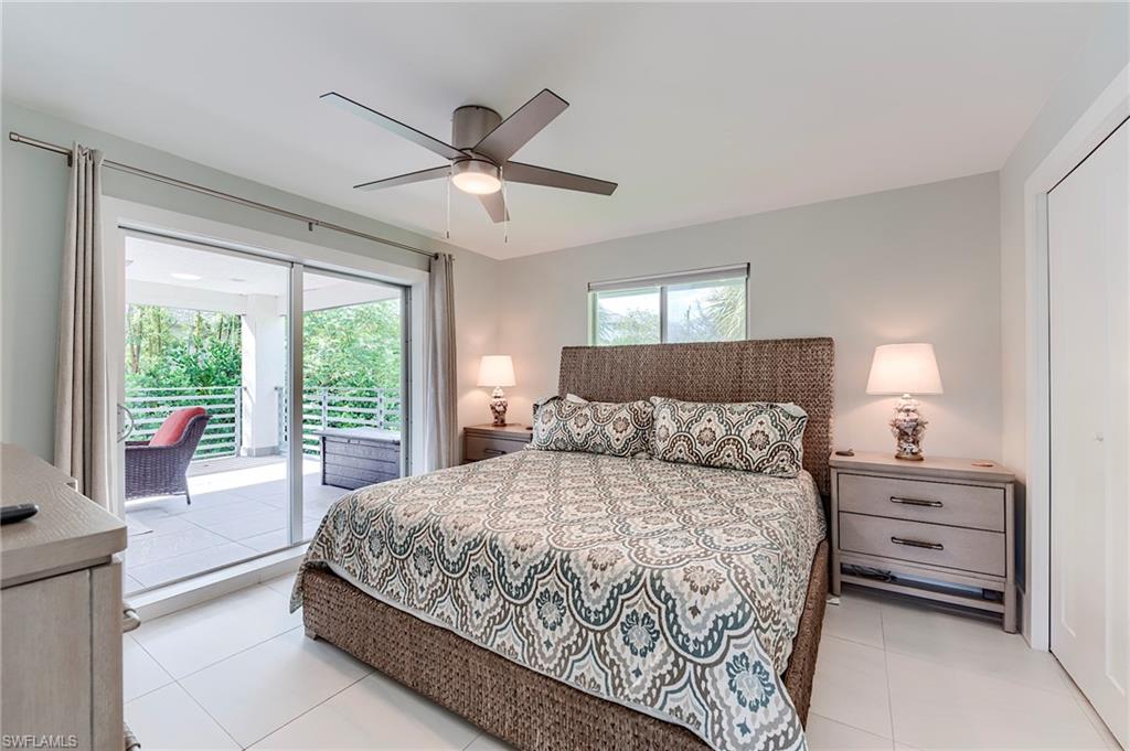 145 Capri Boulevard Naples, FL 34113 - Photo 5 of 33 a bedroom with a large bed and a window