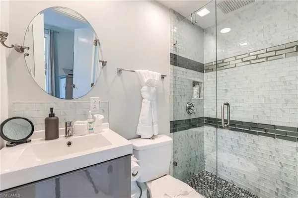 a bathroom with a sink toilet and shower