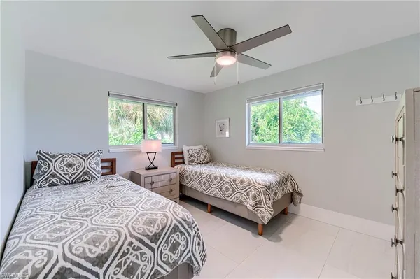 a bedroom with two beds and a window