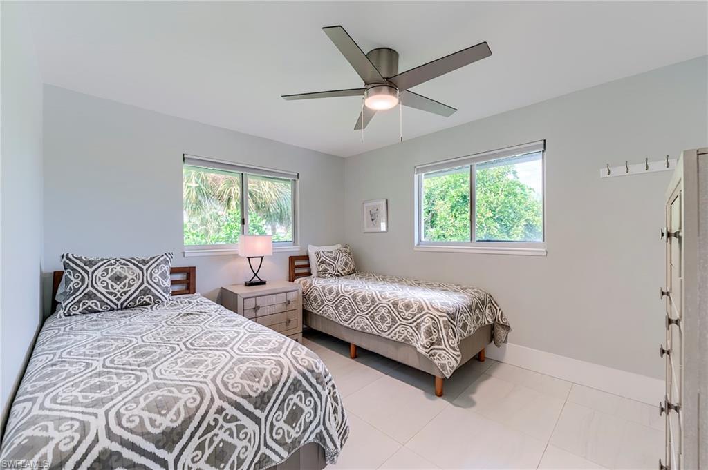 145 Capri Boulevard Naples, FL 34113 - Photo 7 of 33 a bedroom with two beds and a window