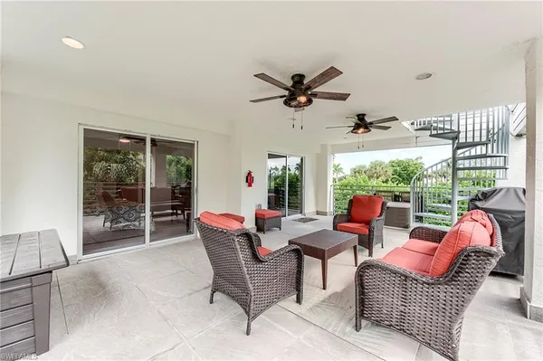 a dining room with furniture a rug and a large window