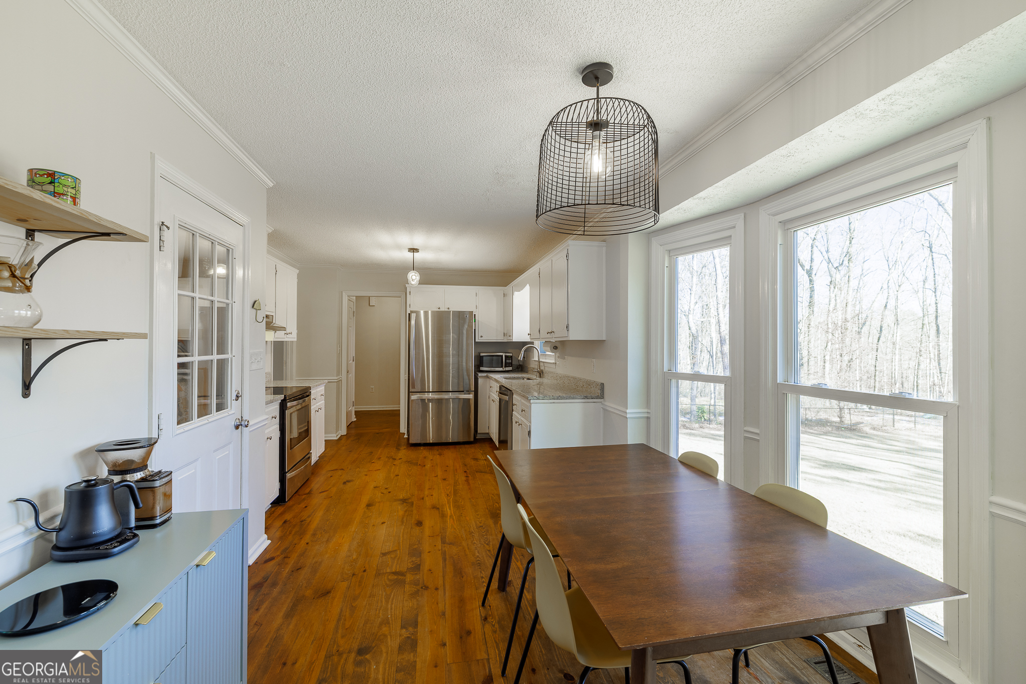 415 Brookstone Drive Athens, GA 30605 - Photo 20 of 55 a open kitchen with stainless steel appliances a dining table chairs and couches with wooden floor