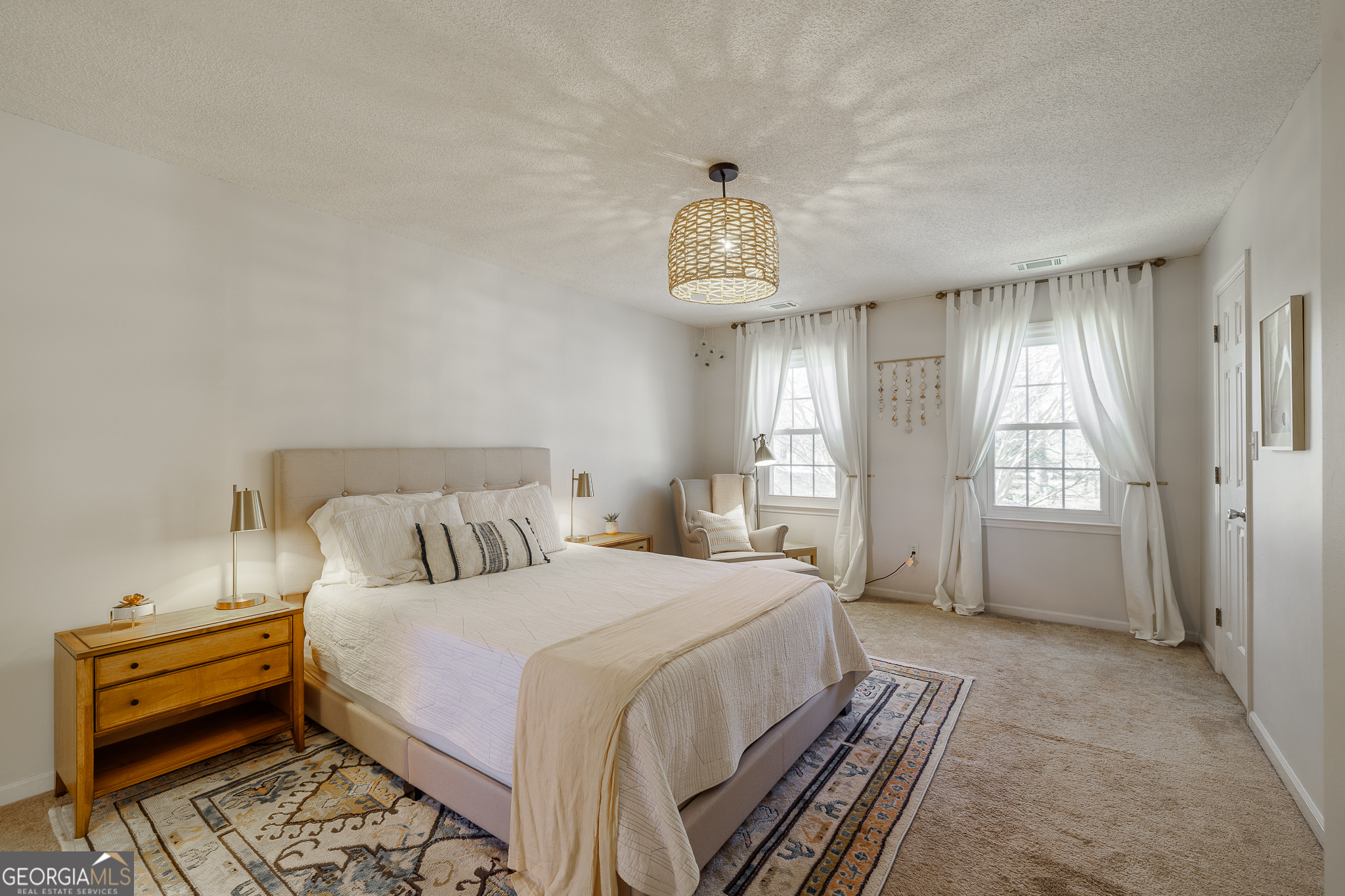 415 Brookstone Drive Athens, GA 30605 - Photo 29 of 55 a spacious bedroom with a bed and a chandelier