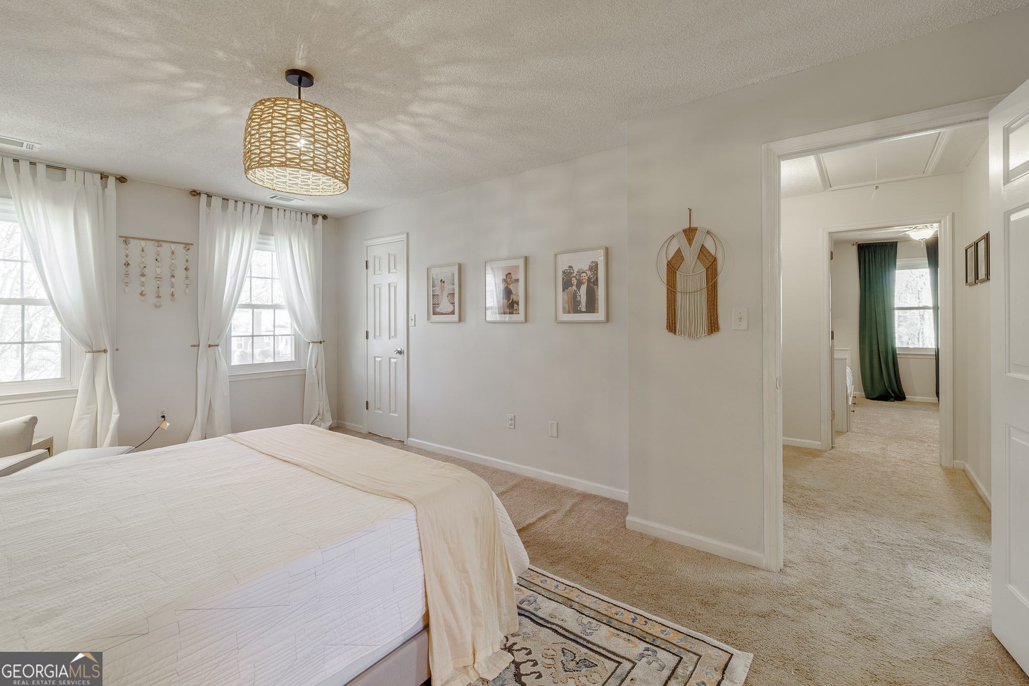 415 Brookstone Drive Athens, GA 30605 - Photo 31 of 55 a bedroom with a bed and a chandelier