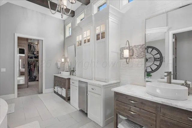 a bathroom with a double vanity sink mirror and shower
