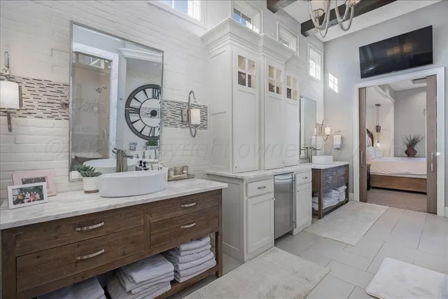 a spacious bathroom with a double vanity sink mirror and bathtub
