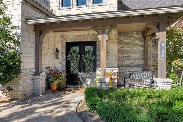 a front view of a house with outdoor seating and plants