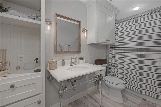 a bathroom with a sink toilet and shower