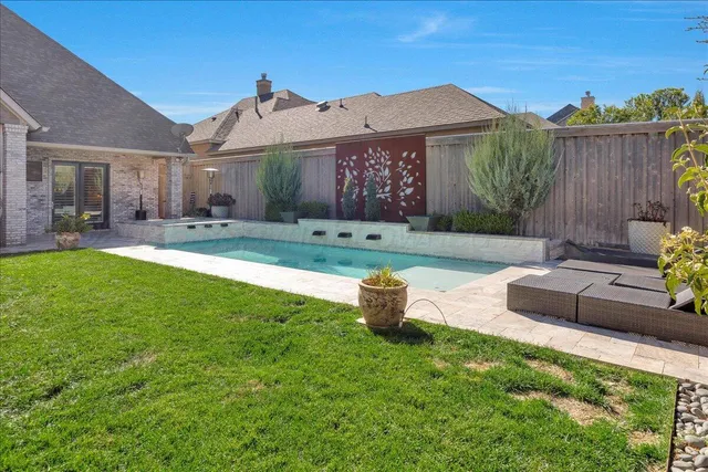 a house view with a sitting space and garden