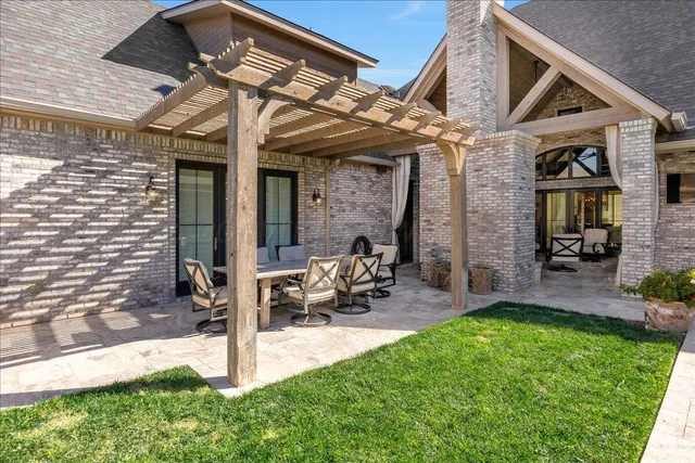 a view of a house with garden and sitting area