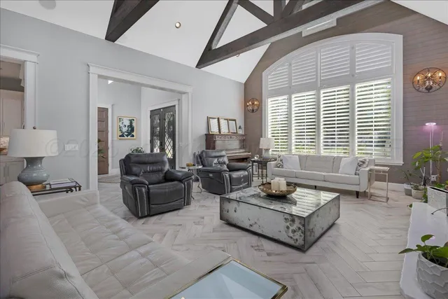 a living room with furniture a window and a table