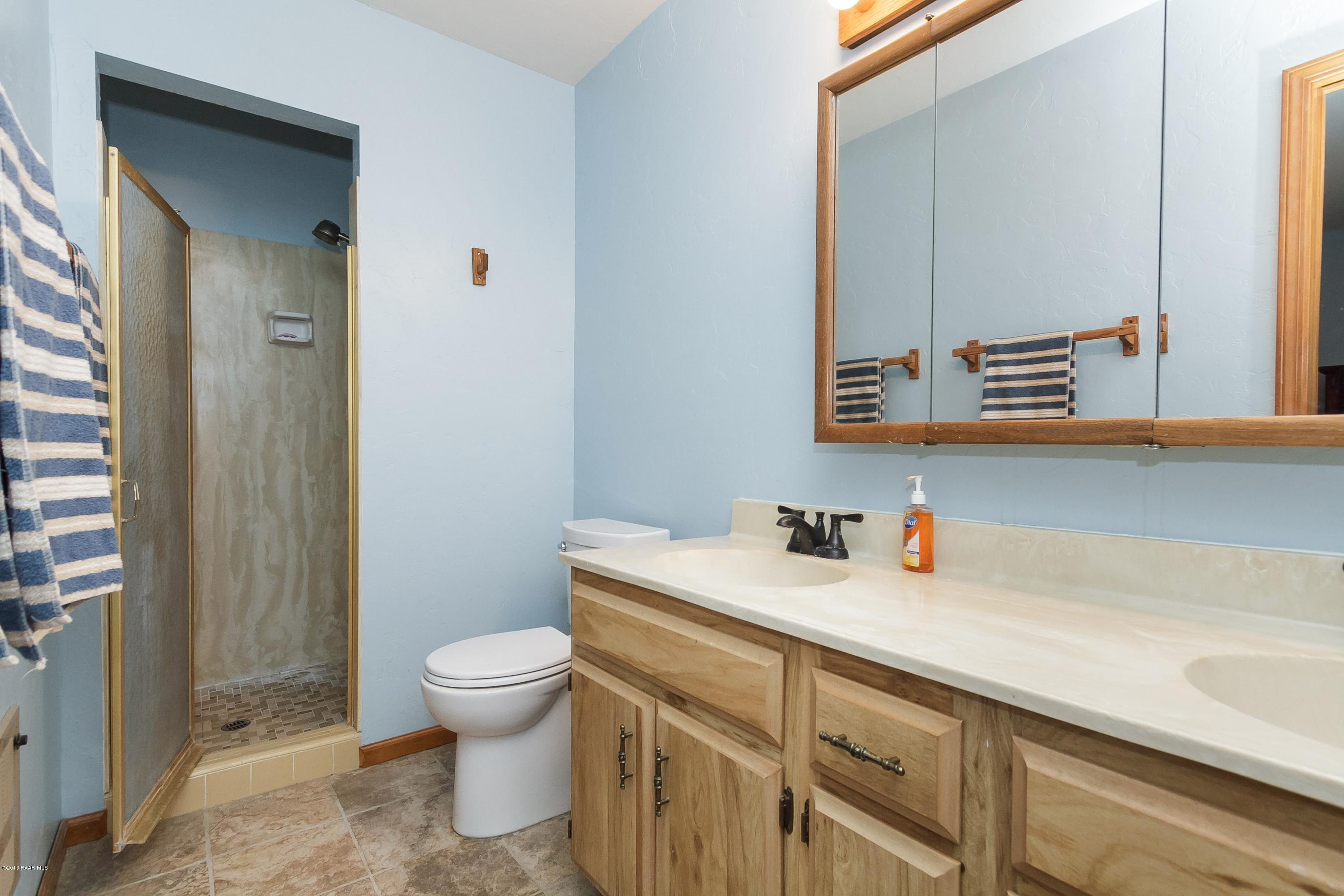 914 Forest Hylands Road Prescott, AZ 86303 - Photo 11 of 22 a bathroom with a sink a toilet and a mirror