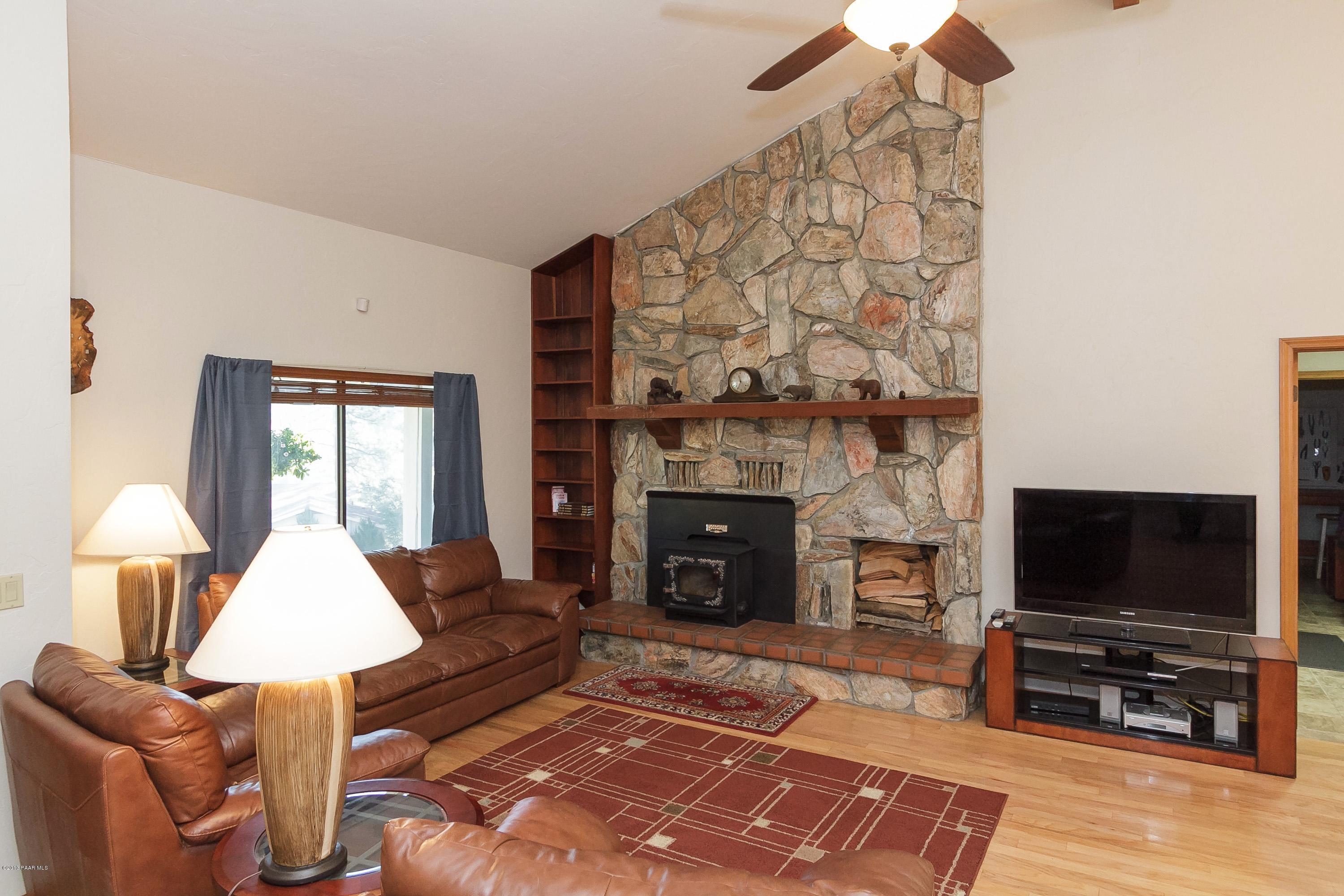 914 Forest Hylands Road Prescott, AZ 86303 - Photo 5 of 22 a living room with furniture flat screen tv and a fireplace