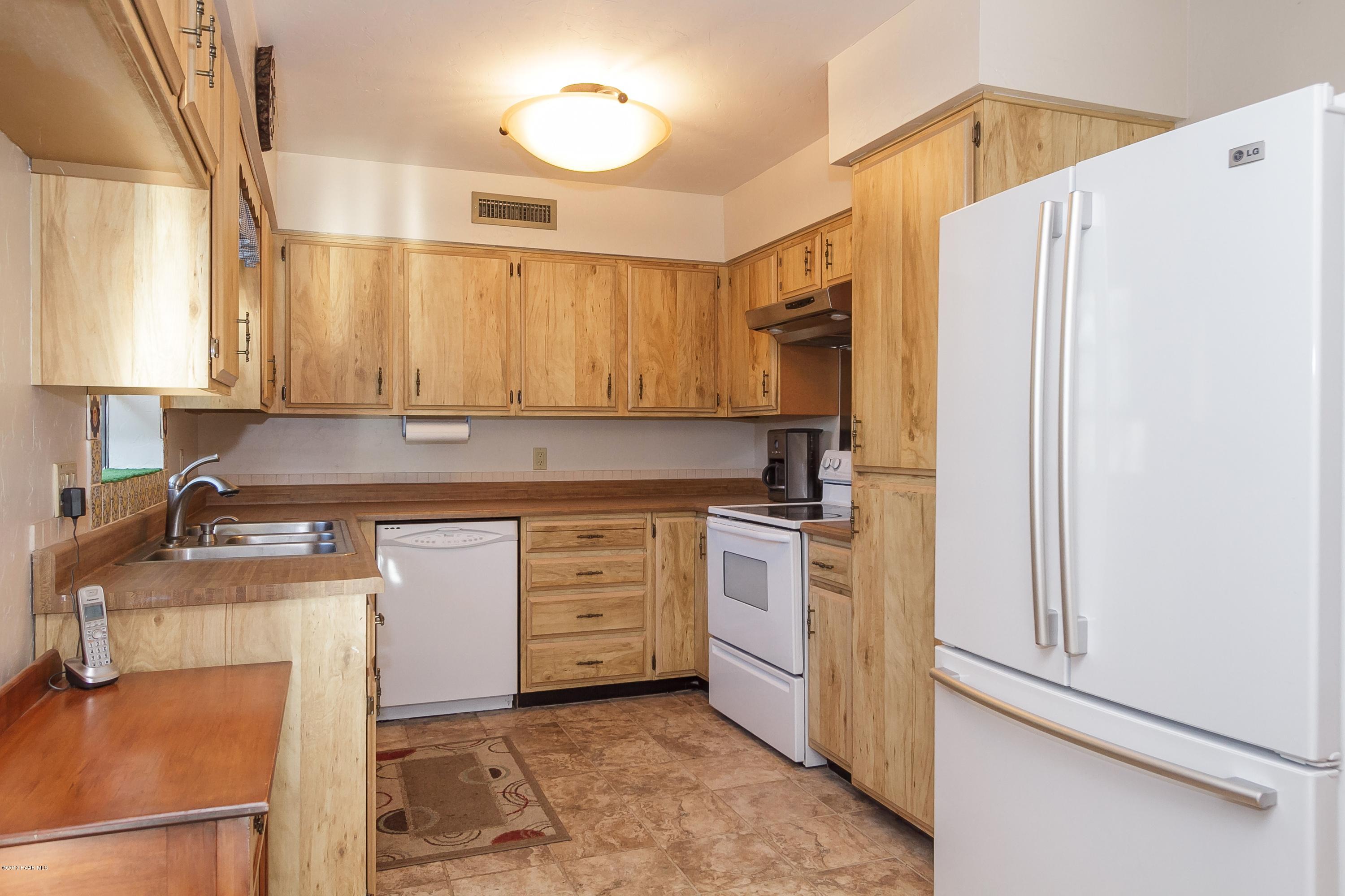 914 Forest Hylands Road Prescott, AZ 86303 - Photo 6 of 22 a kitchen with stainless steel appliances granite countertop a refrigerator sink and stove