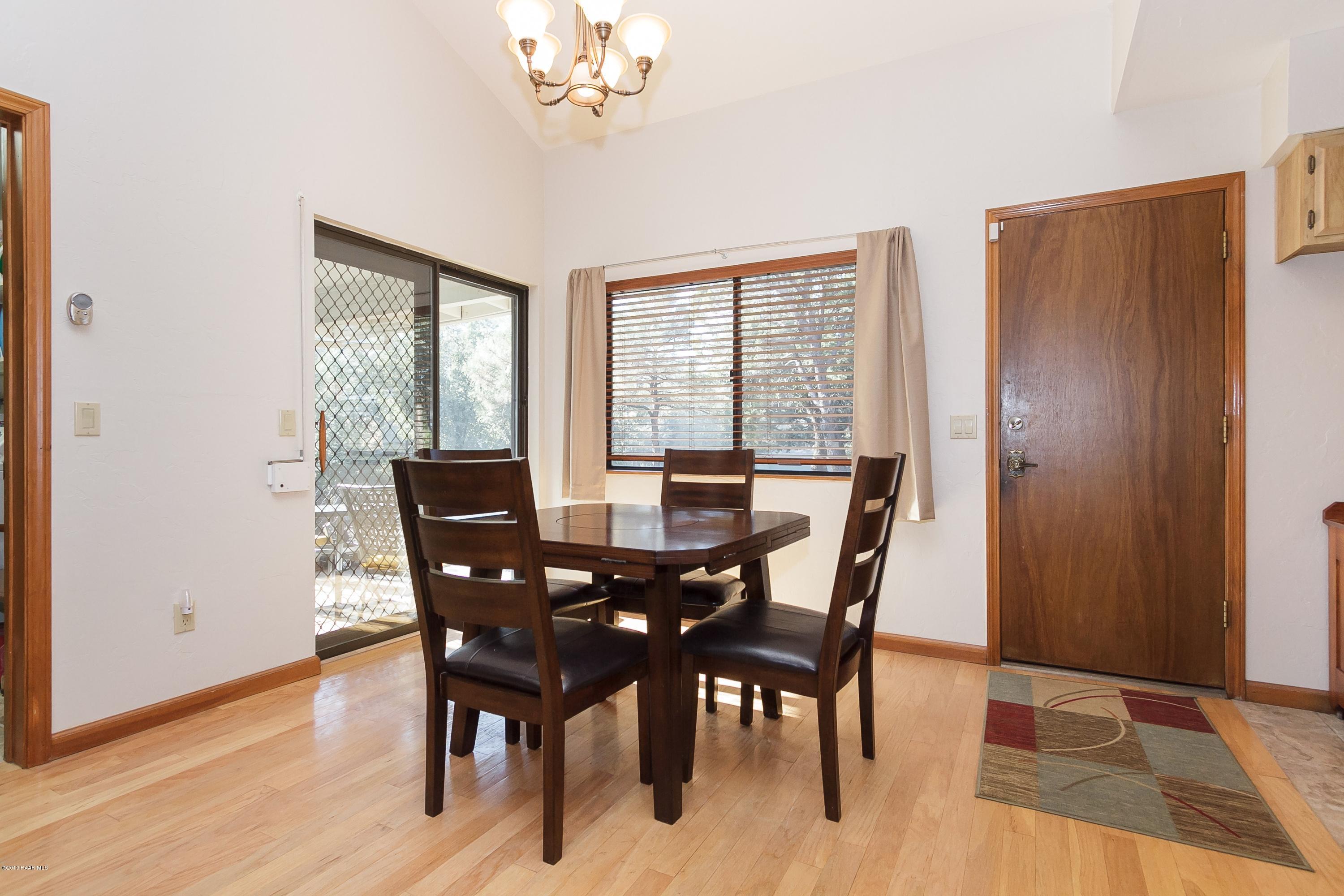 914 Forest Hylands Road Prescott, AZ 86303 - Photo 8 of 22 a view of a dining room with furniture window and wooden floor