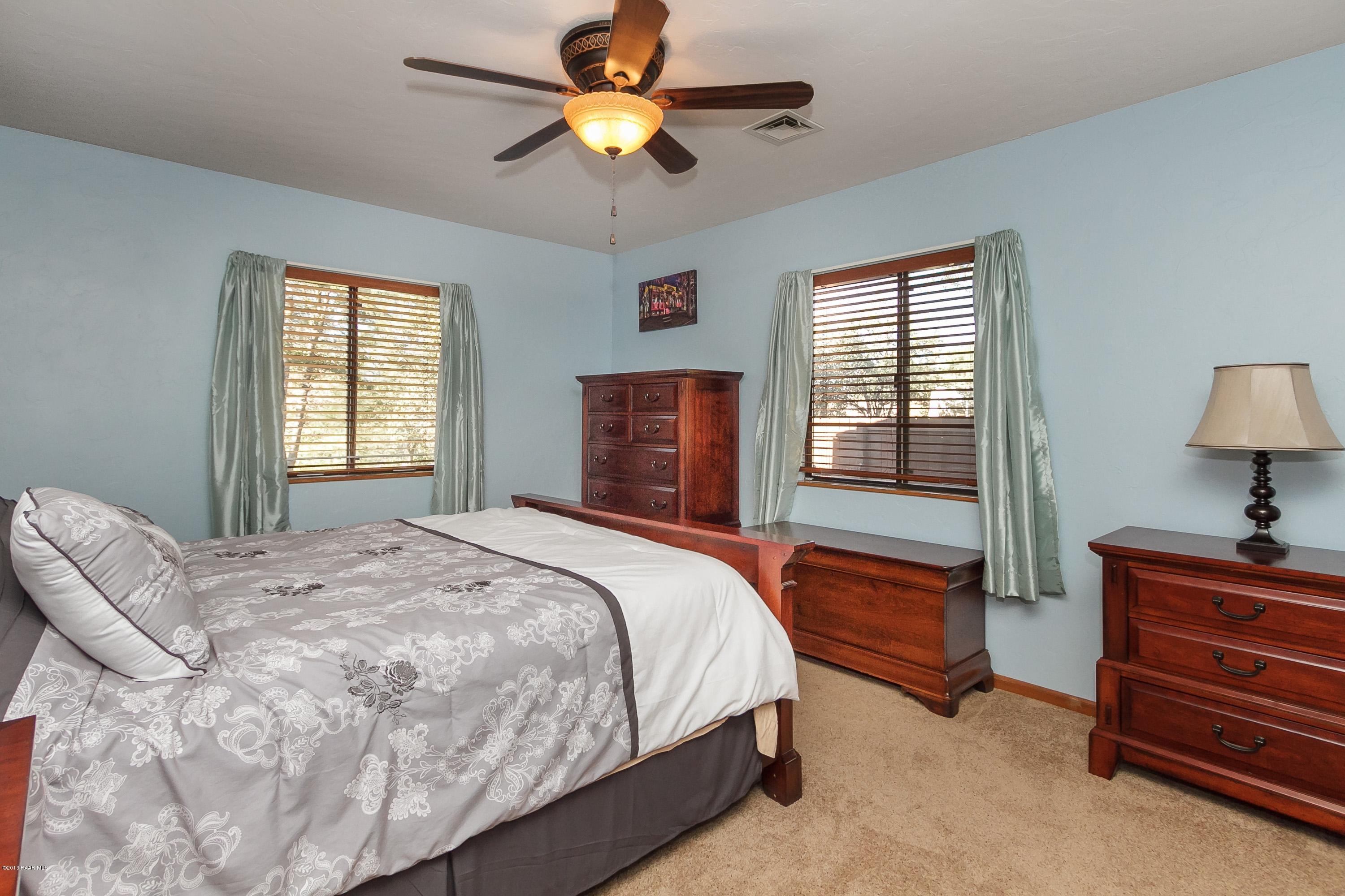 914 Forest Hylands Road Prescott, AZ 86303 - Photo 9 of 22 a bedroom with a bed dresser and a window
