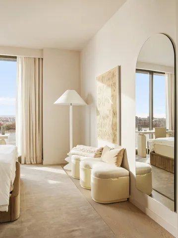 a spacious bedroom with a bed and a window