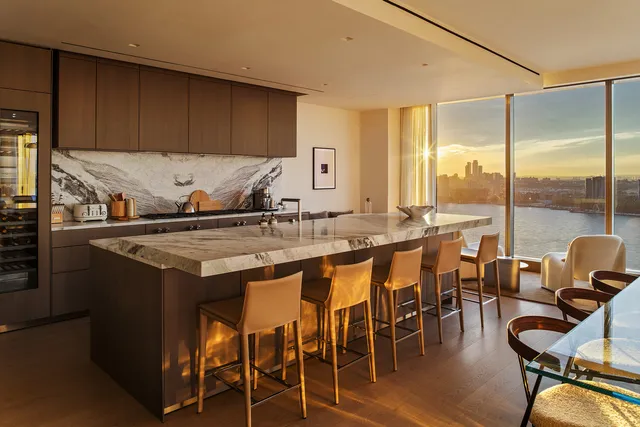 a dining room with furniture and a floor to ceiling window