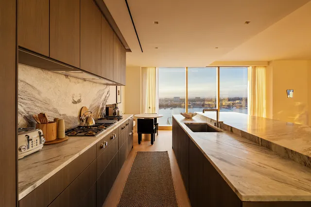 a kitchen with a table chairs stove and sink